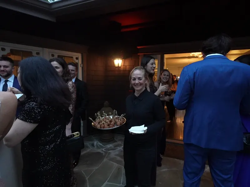 Guests taking bites from a passed appetizer tray at a Petaluma riverfront party