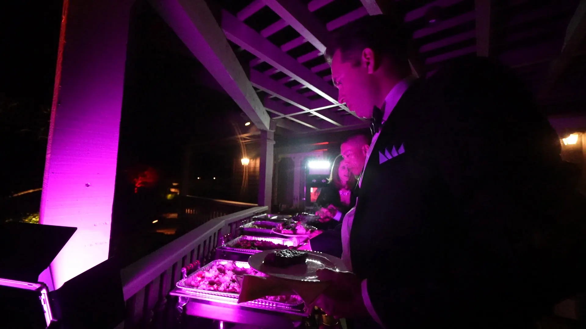 Buffet service under rose-pink evening lighting at a Sausalito waterfront celebration