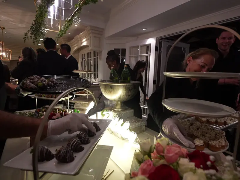 Guests gathered around tiered dessert stands at a Santa Rosa corporate luncheon