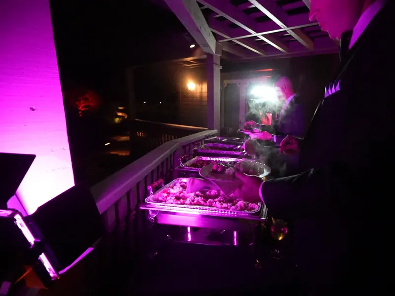 Evening buffet line glowing under warm uplighting at a Marin County corporate event