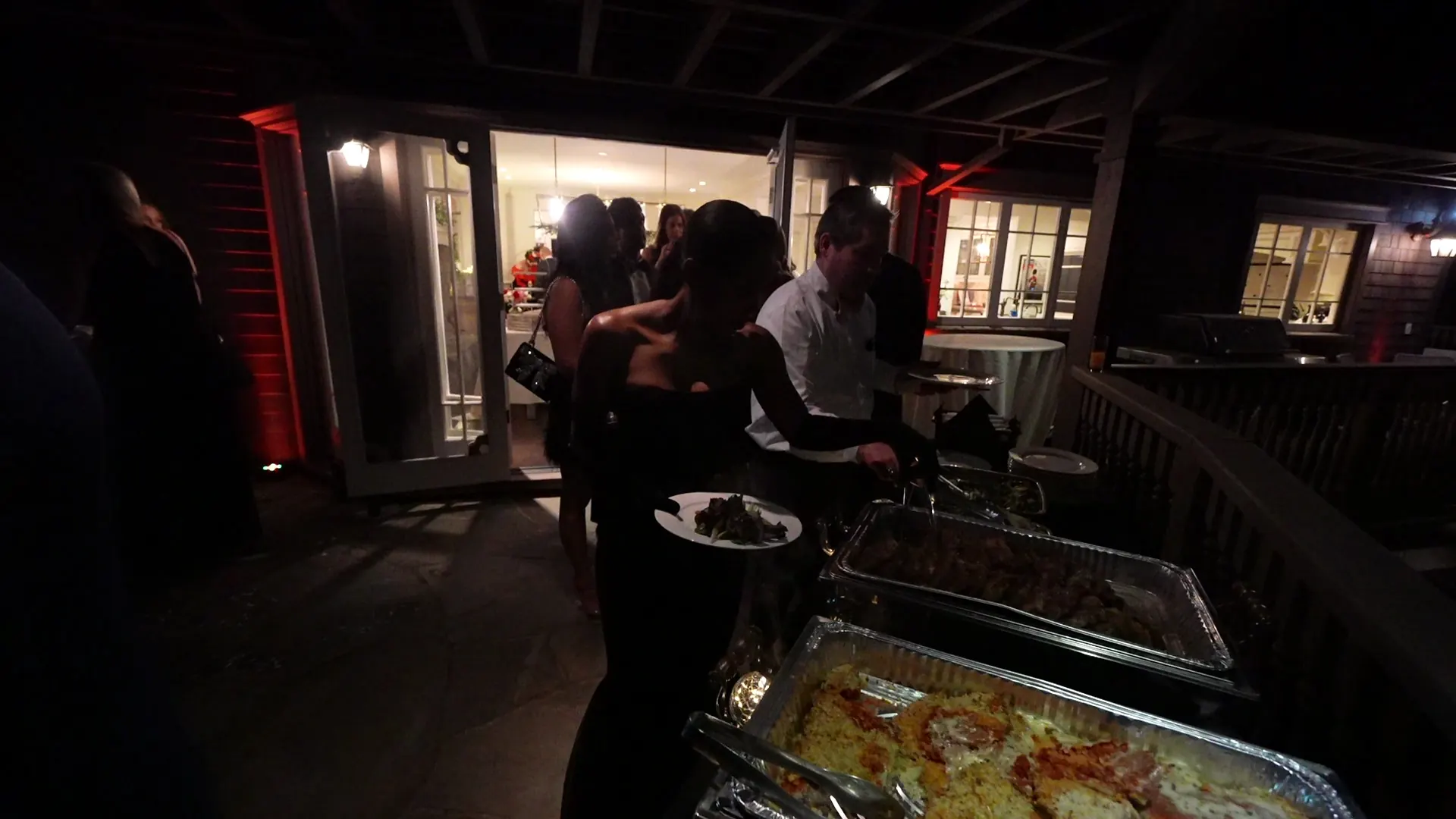 Chafing-dish buffet with guests serving themselves at a Sebastopol orchard-side reception